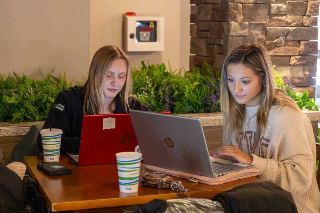 Students gather and socialize inside the MacKenzie Commons building at Alfred State College during the spring semester.
