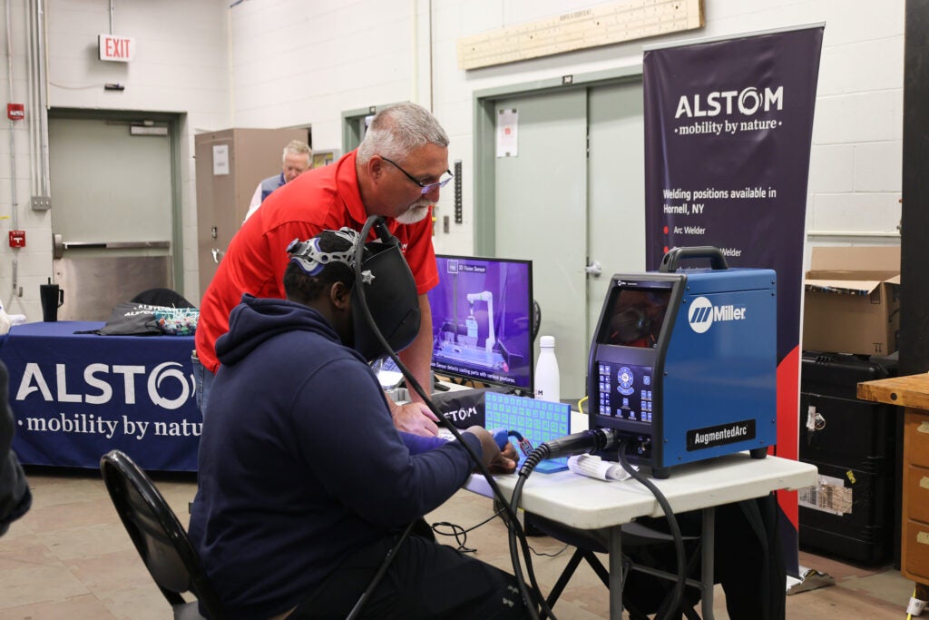 A high school student participates in a welding simulation at a career event open to high schoolers at Alfred State College